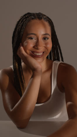 Studio-Beauty-Shot-Of-Young-Woman-With-Long-Braided-Hair-Sitting-At-Table-4